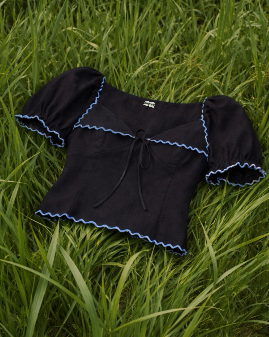 Black top with blue trim on grass