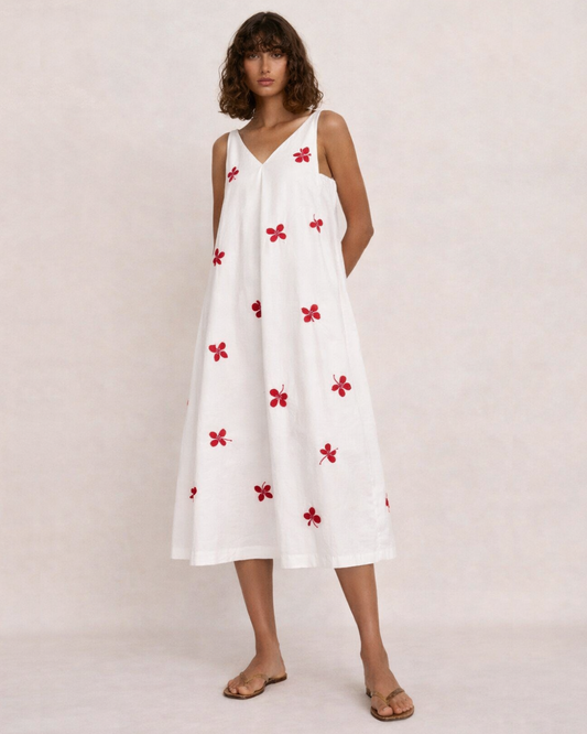 Roma embroidered cotton poplin midi dress by Erna worn by model featuring clover embroidery and A-line silhouette.
